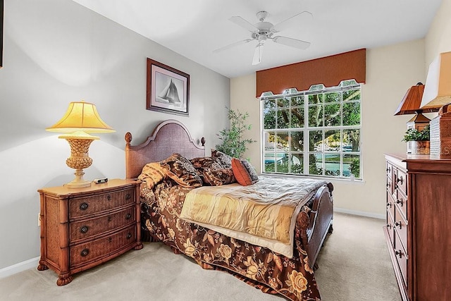 12843 Madison Pointe Cir Unit 107, Orlando, FL 32821 - bedroom featuring light carpet and ceiling fan