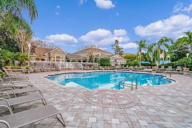 12843 Madison Pointe Cir Unit 107, Orlando, FL 32821 - community pool featuring a patio area