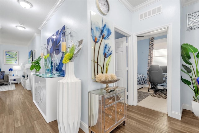 hall featuring hardwood / wood-style flooring and crown molding