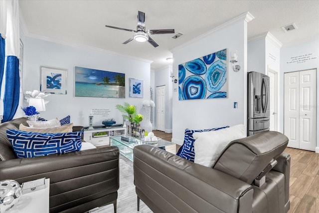 living room featuring hardwood / wood-style floors, ceiling fan, and crown molding