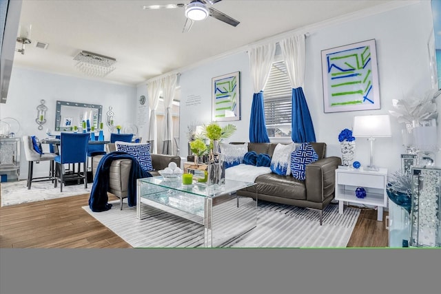 living room featuring ceiling fan, hardwood / wood-style floors, and ornamental molding