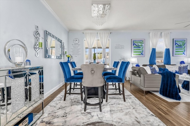 dining space with hardwood / wood-style flooring, a notable chandelier, and ornamental molding