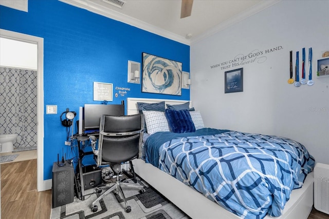 bedroom featuring hardwood / wood-style flooring, ceiling fan, and crown molding