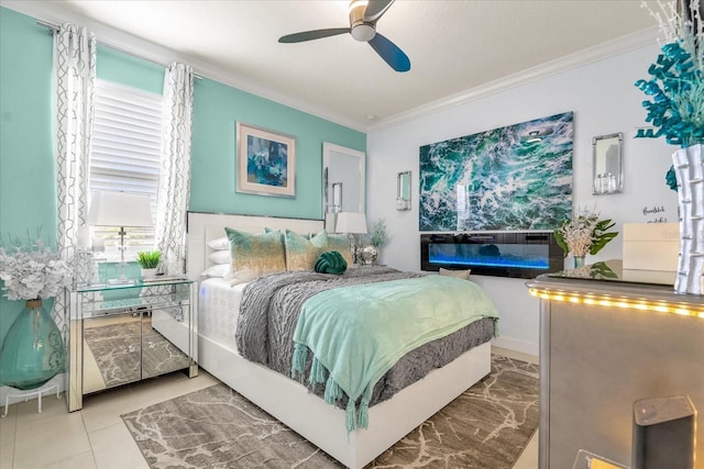 tiled bedroom with ceiling fan and crown molding