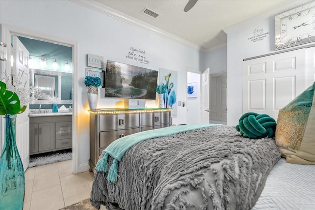 tiled bedroom with a textured ceiling, connected bathroom, ceiling fan, and crown molding