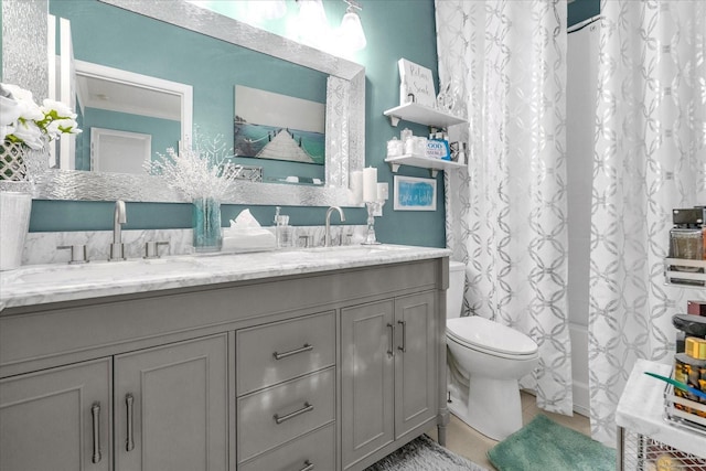 bathroom featuring tile patterned floors, vanity, and toilet