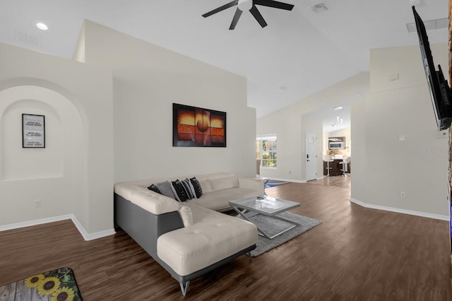 living room featuring ceiling fan, dark hardwood / wood-style flooring, and vaulted ceiling