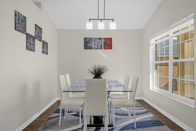 dining room featuring dark hardwood / wood-style flooring and lofted ceiling