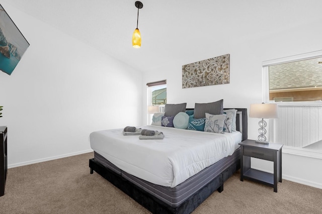 bedroom featuring light colored carpet and lofted ceiling