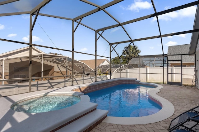 view of swimming pool with a lanai, an in ground hot tub, and a patio