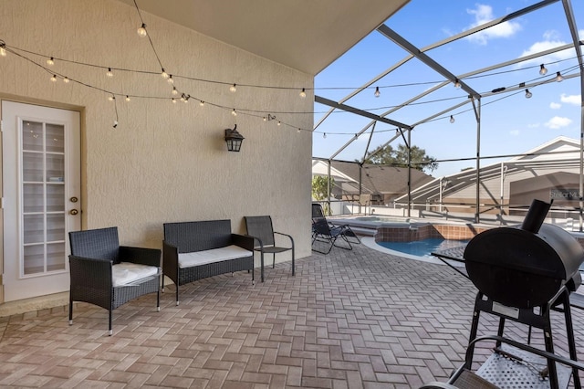 view of patio featuring a lanai, grilling area, and a pool with hot tub