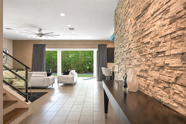 unfurnished living room with light tile patterned floors and ceiling fan