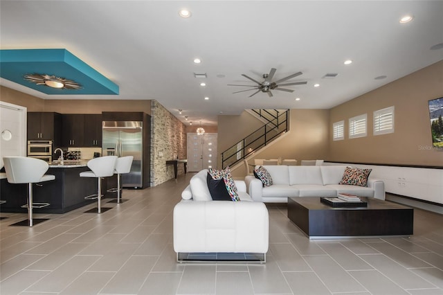 living room with ceiling fan and light tile patterned floors