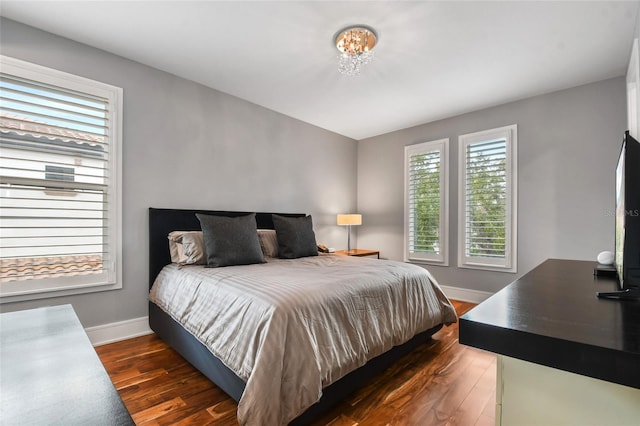 bedroom with dark wood-type flooring