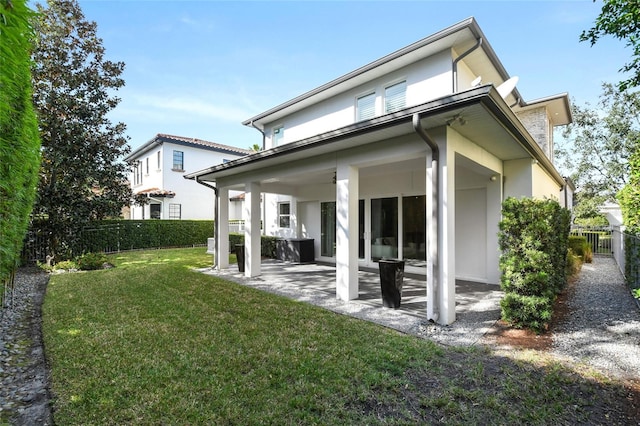 back of property featuring a yard and a patio