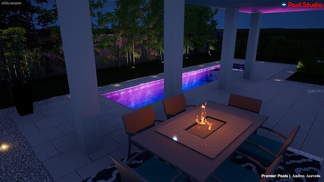 patio at twilight featuring a fire pit