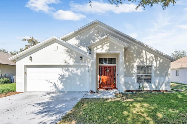 view of front of property featuring a front lawn and a garage