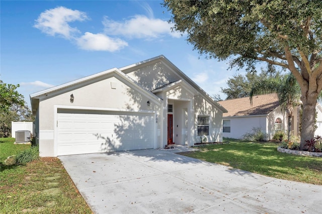 view of front of house featuring a front lawn, central AC unit, and a garage