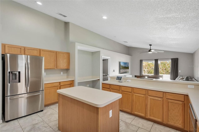 kitchen featuring ceiling fan, stainless steel fridge with ice dispenser, a textured ceiling, lofted ceiling, and a kitchen island