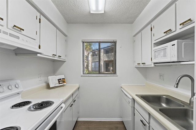 kitchen with sink, white appliances, white cabinets, and a textured ceiling