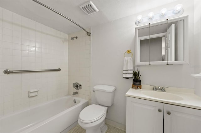 full bathroom featuring tiled shower / bath combo, toilet, tile patterned floors, and vanity