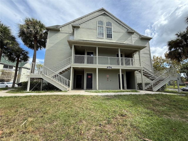 rear view of property with a yard