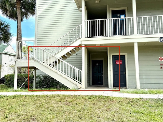 view of exterior entry with a lawn