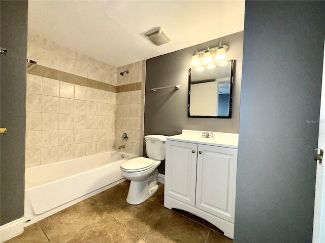 full bathroom featuring tile patterned flooring, toilet, vanity, and tiled shower / bath