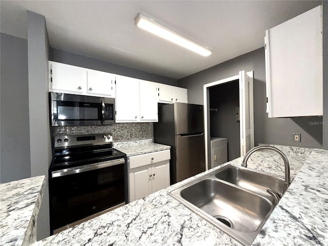 kitchen featuring white cabinets, sink, stainless steel appliances, and tasteful backsplash