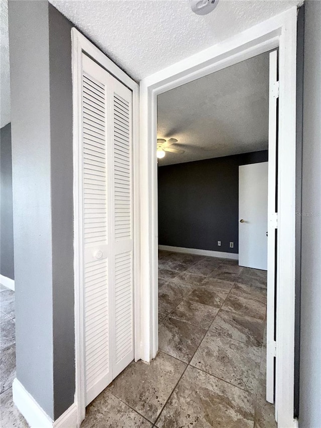 corridor with a textured ceiling