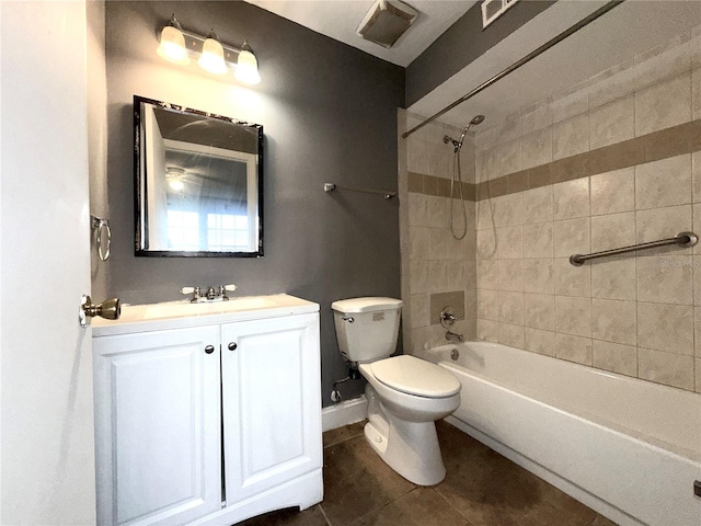 full bathroom featuring toilet, vanity, tile patterned floors, and tiled shower / bath combo