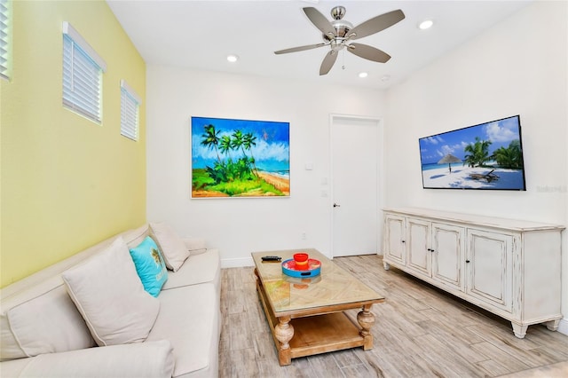 living room featuring light hardwood / wood-style flooring and ceiling fan