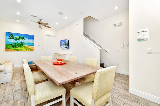 dining space featuring light wood-type flooring and ceiling fan