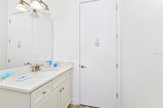 bathroom featuring wood-type flooring and vanity