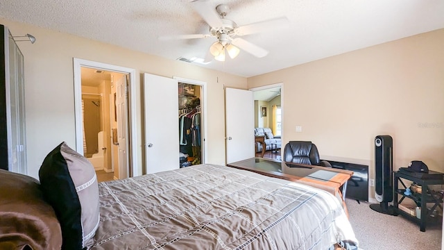 bedroom with carpet flooring, ceiling fan, a textured ceiling, connected bathroom, and a closet