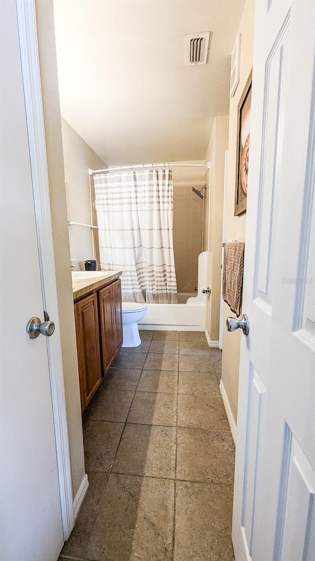 full bathroom with vanity, shower / tub combo, and toilet