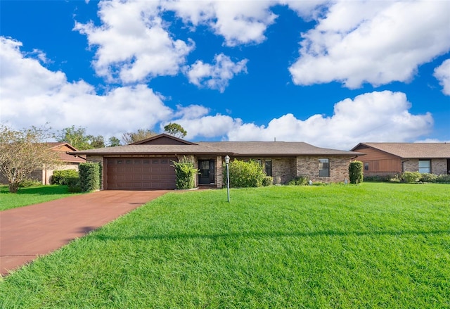 single story home with a garage and a front lawn