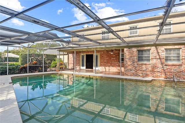 view of pool featuring a lanai, a patio area, and ceiling fan