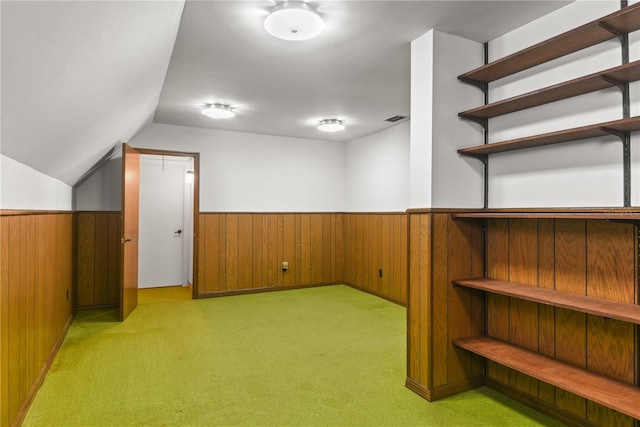 interior space featuring light carpet and wooden walls