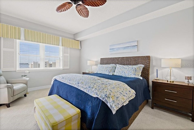 bedroom featuring light colored carpet and ceiling fan