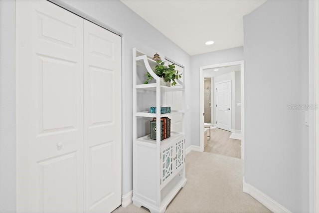 corridor featuring light colored carpet