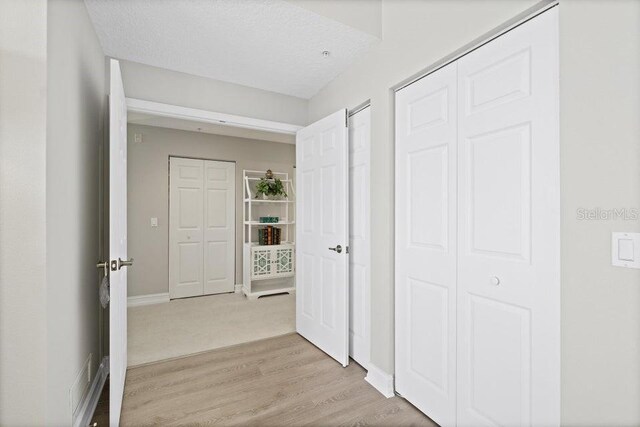 134 Starboard Ln Unit 705, Merritt Island, FL 32953 - hallway featuring light wood-style floors and baseboards