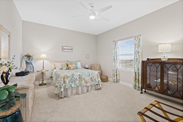 bedroom with ceiling fan and light carpet