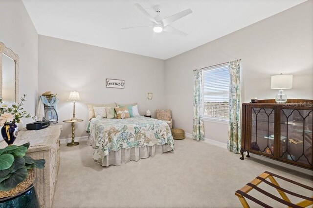 134 Starboard Ln Unit 705, Merritt Island, FL 32953 - carpeted bedroom with baseboards and a ceiling fan