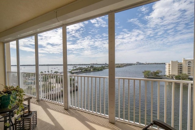 unfurnished sunroom featuring a water view