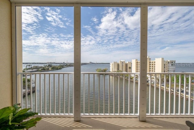 unfurnished sunroom with a water view