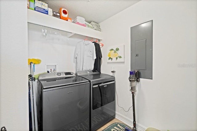 washroom featuring washing machine and dryer and electric panel