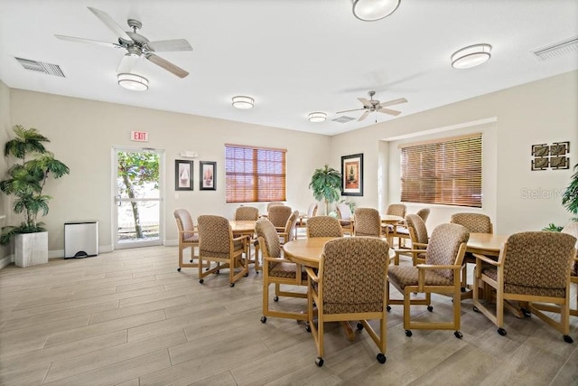 dining space featuring ceiling fan and light wood-type flooring