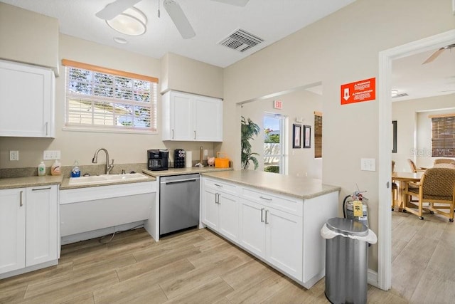 kitchen featuring dishwasher, plenty of natural light, white cabinetry, and sink