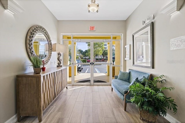 interior space featuring light wood-type flooring and french doors